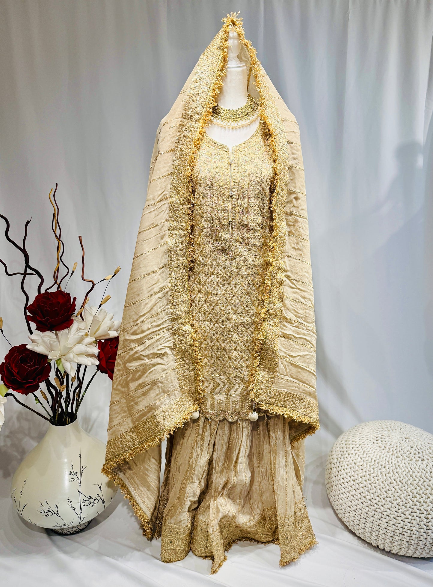 Elegant gold sharara with sequin work on top and sharara and gota jhalar on dupatta