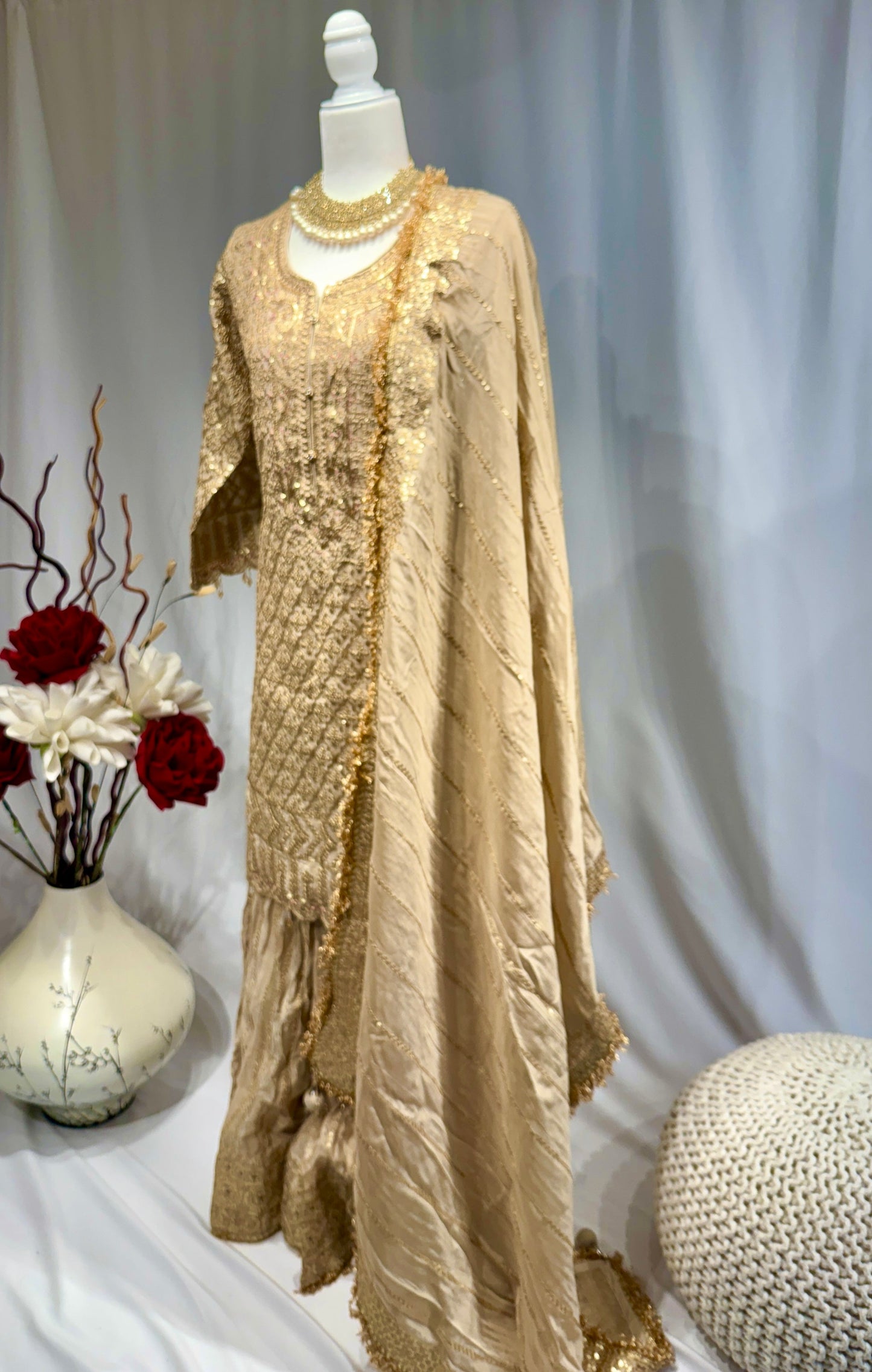 Elegant gold sharara with sequin work on top and sharara and gota jhalar on dupatta