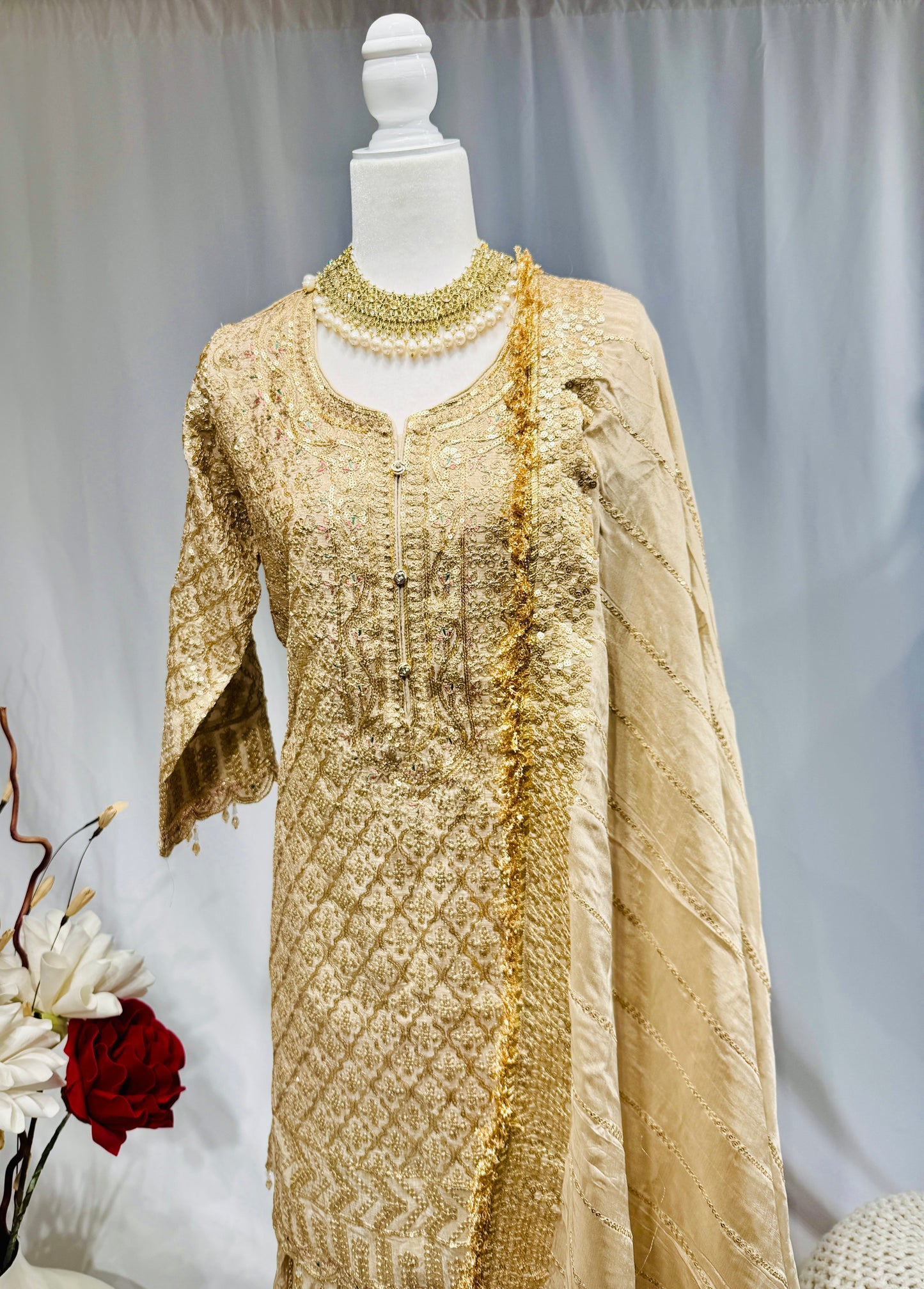 Elegant gold sharara with sequin work on top and sharara and gota jhalar on dupatta